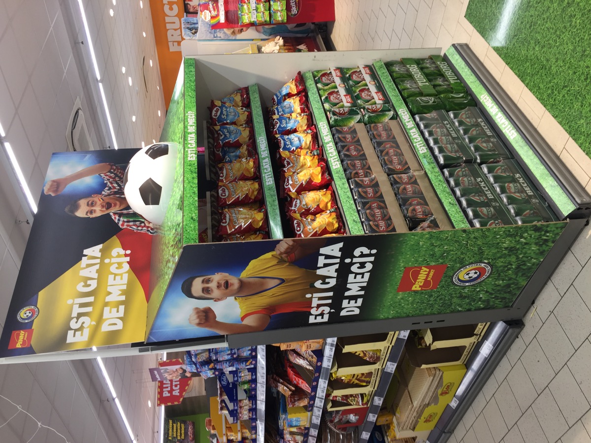 Football themed promotional retail island with snacks and beverages